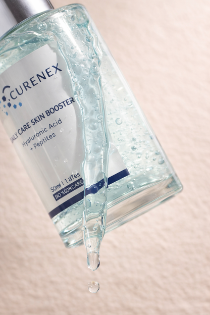 Curenex Daily Care Skin Booster bottle with droplet on a light pink background.