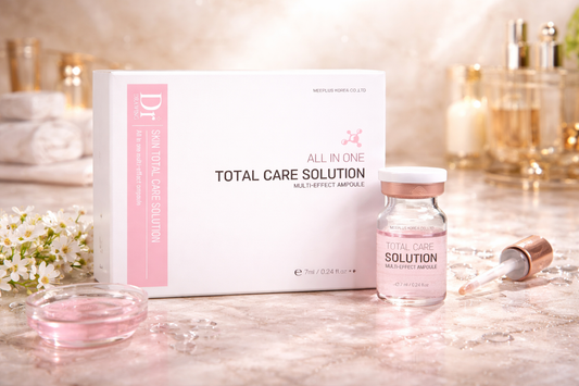 Dr. Drawing Total Care Snail Mucin Ampoule on a marble surface.