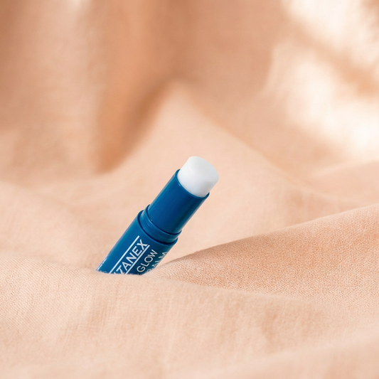 Blue Glutanex Lip Glow Balm with Shea Butter & Glutathione stick on a light rose background.