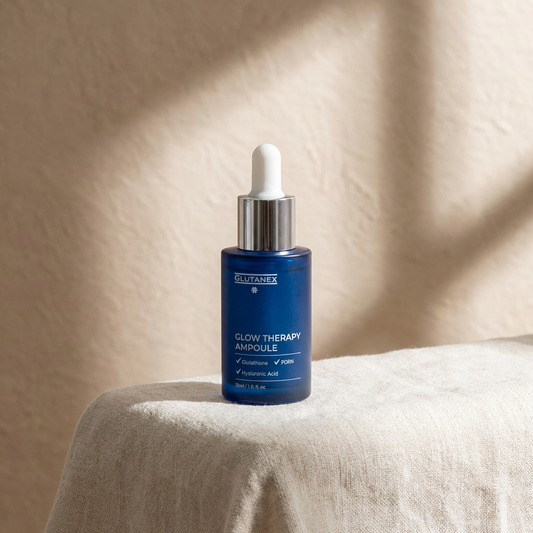 Glutanex Glow Therapy Ampoule bottle on a beige surface with a neutral background
