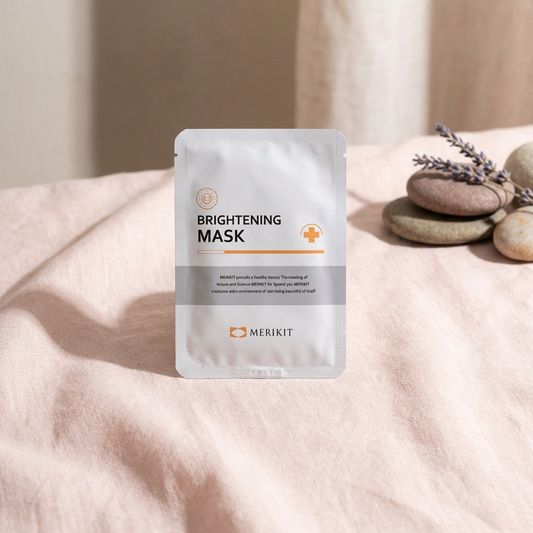 Merikit Brightening Sheet Mask packaging with Merikit branding on a soft fabric background.