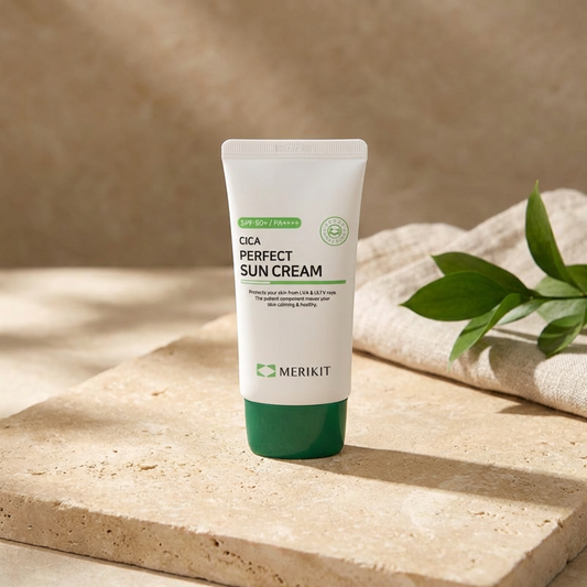 Tube of Merikit Cica Perfect Suncream by Merikit on a wooden surface with a beige background