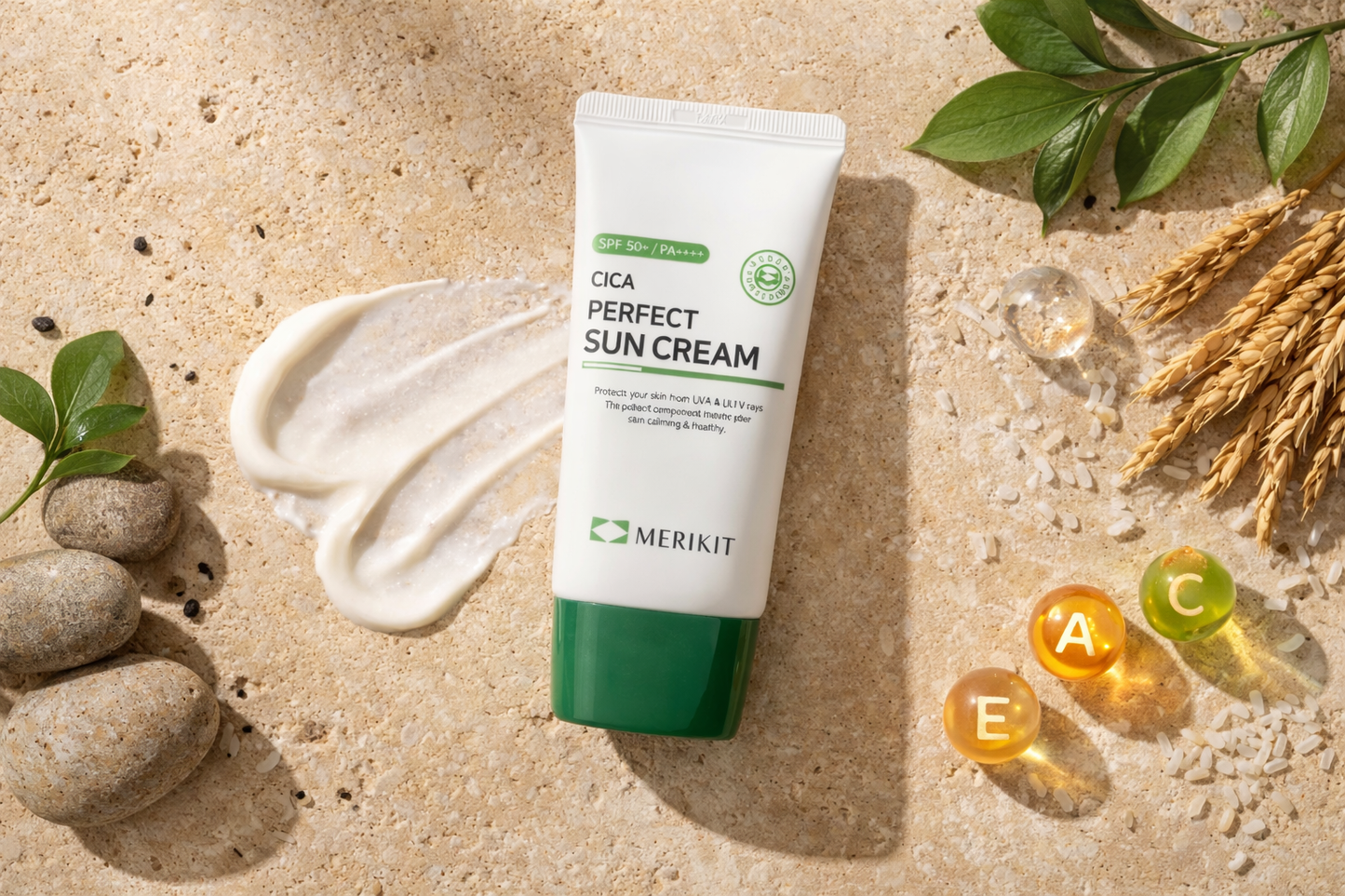 Tube of Merikit Cica Perfect Suncream on a sandy background with leaves and stones.