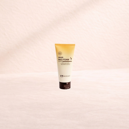 Tube of Merikit Grain Rice Foam on a beige background.