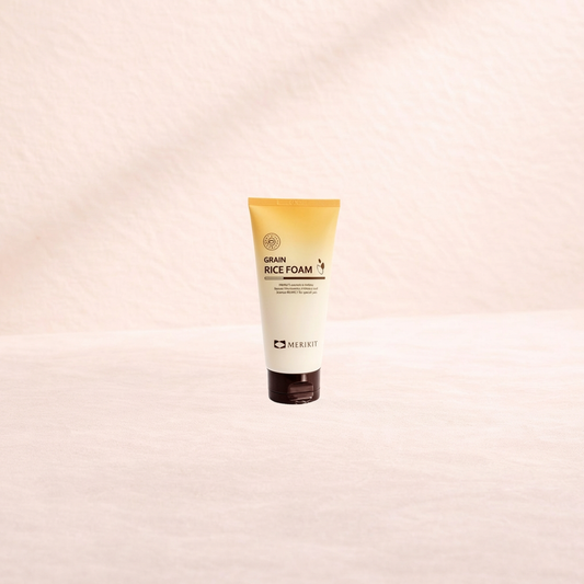 Tube of Merikit Grain Rice Foam on a beige background.